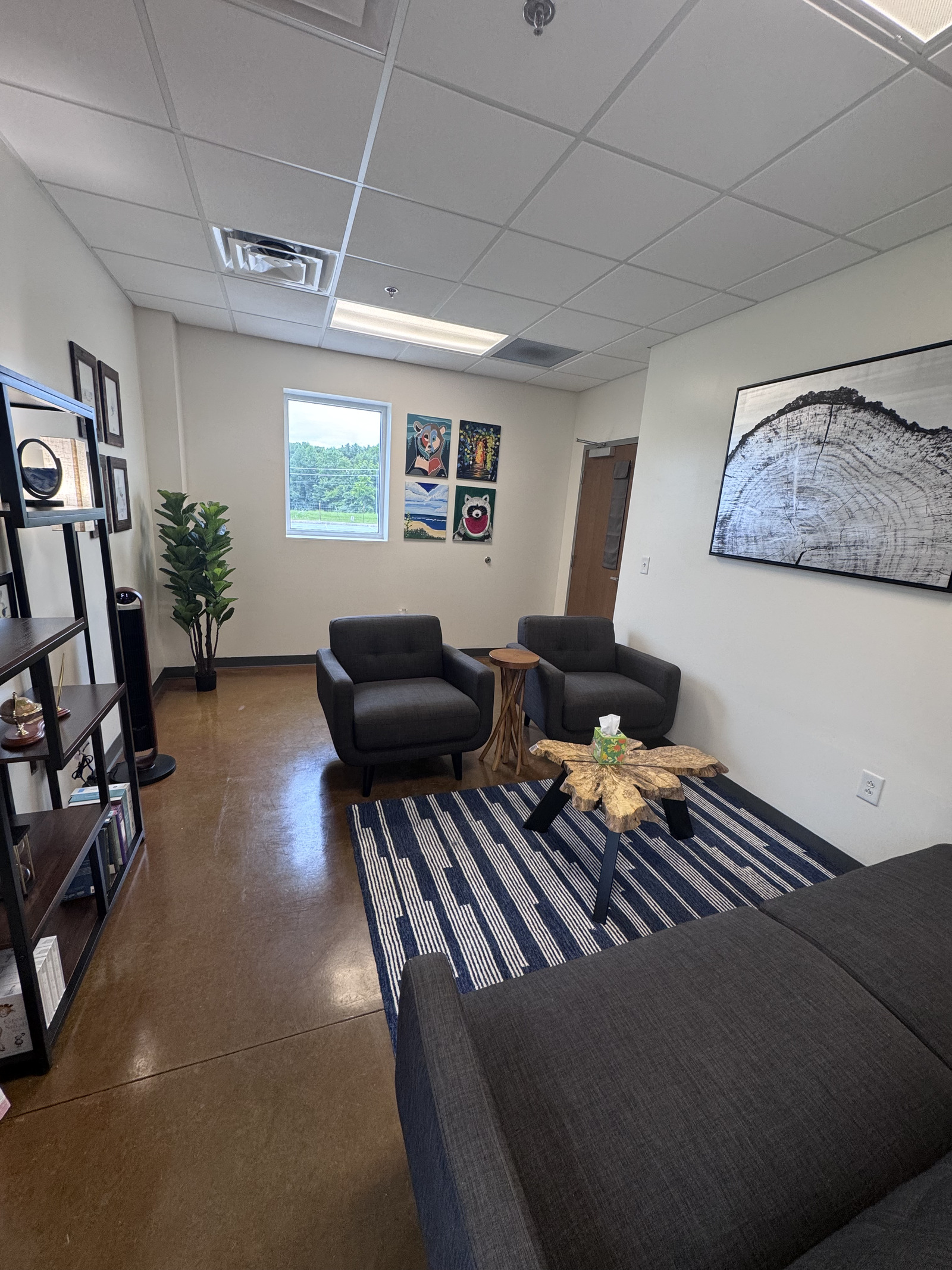 Counseling room at Made For More Counseling in Clarksville, TN with armchairs, sofa, and artwork